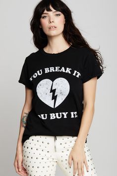 Careful: You Break It, You Buy It! Make a statement with this sassy graphic tee. The design features bold “You Break It, You Buy It” type, and a broken heart. Made with soft cotton fabric, distressed hems, cuffed sleeves, and our popular fitted style. The design of this style is fitted. For a more standard fit, choose a size up. Details Style #302256 Color: Black You Break It You Buy It Broken Heart Fitted T-Shirt 100% Cotton Care/Import Machine Wash Cold, Tumble Dry Low Designed and Finished in Heart Tee, Fitted Style, Retail Therapy, Cuff Sleeves, Workout Tee, Fashion Tees, Design Features, Graphic Tee, Graphic Tees