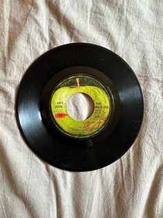 an old black record on a white sheet