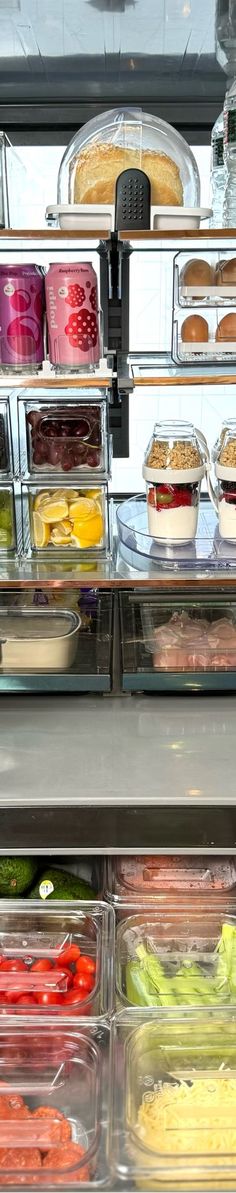 an assortment of food items displayed on shelves in a display case at a store or restaurant