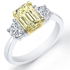 a yellow and white diamond ring with three diamonds