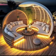 an outdoor seating area with lights on the floor and round couches in the center