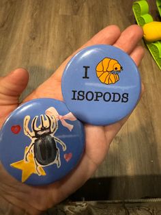 someone holding two badges that say i love ispoods and an antelope