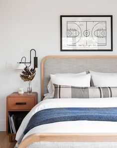 a bedroom with a basketball court on the wall above the headboard and bedding