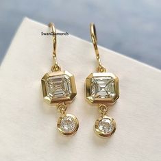 Bezel Setting Asscher And Round Cut Diamond Earrings, Moissanite Dangle Drop Earrings, 14K Solid Yellow Gold Ear Wire Earrings, Wedding Gift ❁Description❁ Moissanite & Simulated Stone: ----------------------------- Stone Shape: Asscher Cut, Round Cut Stone Size:  6 mm, 3.50 mm Weight: 2.84 TCW Color: Colorless Cut: Excellent Clarity: VVS ❁ You Can be Planning to place your custom order, Then Do it by onwards. ↣ handmade moissanite made by craftsman with full of festinating and brilliance. As wel Gold Bridal Earrings With Brilliant Cut Dangle, Asscher Cut Diamond Accent Earrings For Wedding, Anniversary Bezel Set Dangle Diamond Earrings, Wedding 14k Gold Diamond Dangle Earrings, Yellow Gold Earrings With Bezel Setting For Wedding, Gold Diamond Earrings With Bezel Setting For Wedding, Anniversary Bezel Set Dangle Earrings, 14k Gold Bezel Set Diamond Earrings For Wedding, 14k Gold Diamond Earrings With Bezel Setting For Wedding