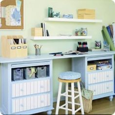 a blue desk with two drawers and a stool