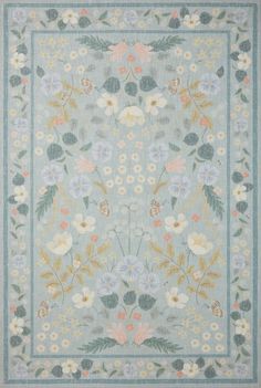 a blue rug with flowers and leaves on it