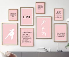 pink and white art prints on the wall above a desk