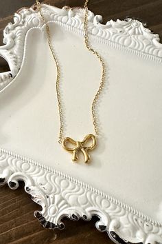 Get ready to amp up your style with our adorable Dainty Bow Necklace! Wrap yourself in charm and sweet simplicity with this gorgeous necklace featuring a tiny bow pendant. Timeless Design: The delicate bow design adds a timeless and feminine touch to your style. High-Quality Stainless Steel: Crafted with precision and durability in mind, our necklace is made from high-quality stainless steel, ensuring longevity and resistance to tarnish. Versatile Finishes: Choose between the classic elegance of Minimalist Party Jewelry With Bow, Feminine Jewelry With Decorative Bow For Gift, Chic Charm Necklaces With Delicate Chain For Gift, Chic Jewelry With Bow For Gift, Chic Clavicle Chain Charm Necklace For Gift, Chic Jewelry With Ribbon For Gift, Chic Clavicle Chain Charm Necklace As Gift, Chic Ribbon Jewelry For Gifts, Cute Jewelry With Butterfly Knot For Gifts