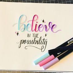 some pens and markers are sitting on top of a piece of paper that says believe in the possibility