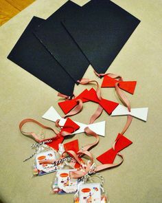 several pieces of paper and ribbon laid out on a table