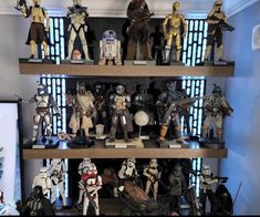 star wars action figures on shelves in a room