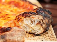 a close up of a pizza on a cutting board