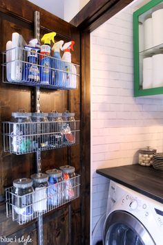 a washer and dryer sitting next to each other in a room with white brick walls