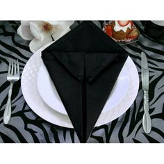 a black napkin on top of a white plate