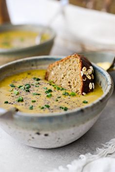 there is a bowl of soup with bread in it