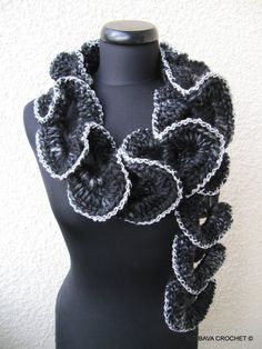 a black and white crocheted scarf on a mannequin