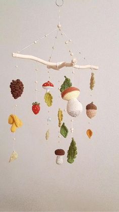 a crocheted mobile with fruits and nuts hanging from it