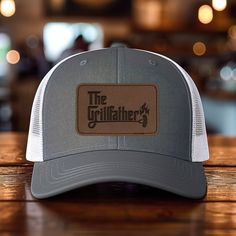 *Add some personality to your wardrobe with our leather patch hat design. *60% cotton/ 40% polyester, 100% polyester mesh backed trucker snapback cap, faux-leather laser engraved patch *Structured six-panel, mid-profile with pre-curved bill and adjustable plastic snapback closure *One size first most. Hat sizing: 7 - 7 3/4 inches, crown height approx 6 1/2 " *Faux-leather patches are engraved in the USA Gray Trucker Hat With Logo Patch, Outdoor Trucker Hat With Letter Patch And Flat Bill, Leather Patch Trucker Hat With Curved Bill, Trucker Baseball Cap With Leather Patch, Outdoor Trucker Hat With Letter Patch And Curved Brim, Outdoor Trucker Hat With Leather Patch And Flat Bill, Brown Trucker Hat With Letter Patch For Outdoor, Outdoor Hats With Leather Patch And Curved Bill, Brown Snapback Hat With Letter Patch For Outdoor