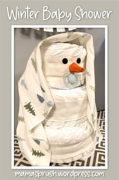 a snowman wrapped in a blanket with the words winter baby shower