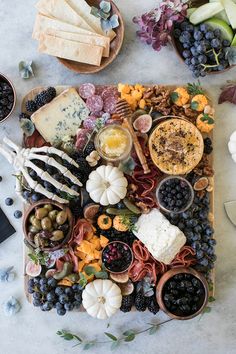 a platter filled with different types of food and fruit on top of a table