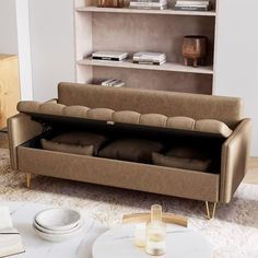 a living room with a couch, table and bookshelf in the back ground