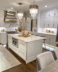 a large kitchen with white cabinets and an island