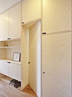 an empty closet with shoes on the floor and shelves in front of it that are open