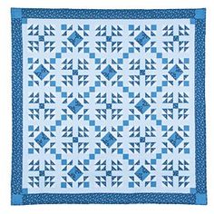 a blue and white quilt with squares on the front, one block in the middle