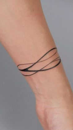 a woman's arm with a tattoo on it that has two lines in the middle