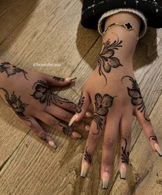 two hands with tattoos on them, one is holding the other's hand and the other