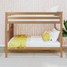 a wooden bunk bed sitting in front of a pink wallpapered wall with white and yellow pillows