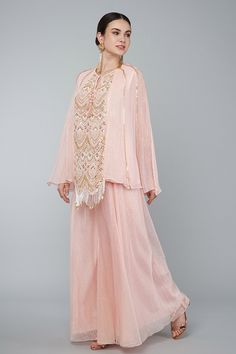 Blush pink georgette panelled embroidered lined tunic with pearls, zari work in art deco motifs and tassel details. Comes with gold zari palazzo.
Component: 2
Pattern: Embroidery
Type Of Work: Pearl,zari
Neckline: Round
Sleeve Type: Split sleeves
Fabric: Georgette,Organza
Color: Pink
Other Details: 
Pearl,zari embroidery
Art deco motifs
Tassel details
Occasion: Destination Wedding - Aza Fashions Art Deco Motifs, Zari Embroidery, Palazzo Set, Zari Work, Pattern Embroidery, Embroidered Tunic, Fashion App, Pink Pearl, Set For Women