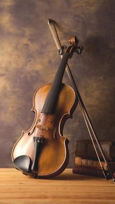 a violin sitting on top of a wooden table