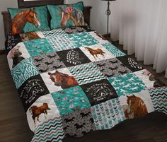 a bed covered in a blue and white quilt with horses on it