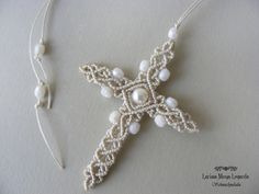 a white beaded cross with pearls on it