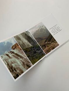 an open book with pictures of mountains and water on the pages is shown in this image