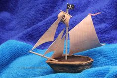 a toy sailboat on a blue blanket