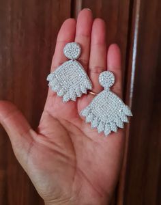 Handmade white beaded flower bridal earrings. The stunning pair of floral bridal earrings are hand-embroidered of white tiny seed beads. These are light weight and ideal option for the Brides. Earrings measure approx. 2.10" long and 1.75" wide. At Carnation jewellery, each piece is artisan handcrafted with love and care and shipped from India.  * SHIPPING - Please refer to the "announcement" page of the store. * Please be noted all kind of taxes, custom duties, VAT etc will be borne by the buyer as I am not responsible for the same. * For queries, please reach out to me and I shall revert ASAP. * PLEASE READ CAREFULLY THE SHOP ANNOUNCEMENT. Back to the store https://www.etsy.com/your/shops/ Carnation jewellery Brides Earrings, White Flower Earring, Earring Wedding, Flower Earring, Bride Earrings, Earrings Beaded, Custom Earrings, Earrings White, Floral White