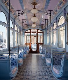 the inside of a train car with blue and white seats