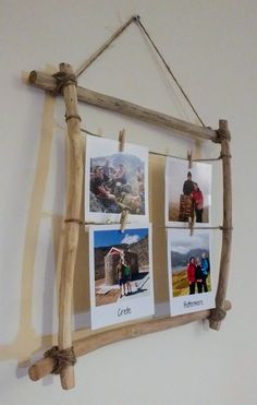 a wooden frame with pictures hanging on it's side and rope attached to the wall