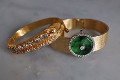 "Fine watch bracelet set with a jade donut and accented with diamonds in 18k. The donut is a deep green Omphacite jade, in parts dark and light like a globe lit. This jewel borrows the perfect finish of a Vacheron watch, its Omega straps in original burnished solid gold. More than a conversion piece, this bracelet could not have been refined to a sleeker layout. At 2cm, the donut is considered big yet its size is offset by the straps, and vice versa. The straps though wide feel made for its cent Timeless Green Jewelry For Evening, Timeless Green Evening Jewelry, Luxury Jade Bracelets For Formal Occasions, Evening Bracelets With Polished Finish, Luxury Formal Jade Bracelets, Elegant Jewelry And Watches With Single Cut Diamonds, Luxury Oval Jewelry With Diamond Hour Markers, Timeless Green Jewelry With Single Cut Diamonds, Fine Jade Jewelry For Formal Occasions