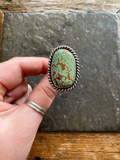 Handmade Pilot Mountain Turquoise and sterling silver statement ring.  -Ring will fit US Size 10.5 American Southwestern Vintage style design. Beautiful Minty green color with warm brown matrix.  High Grade Pilot Mountain turquoise stone. Chunky twisty rope like trim, and freeform shape. Hand polished Rustic looking patina with high polish finish.  chunky Double split style shank/band.  Hand stamped Rising Sun and Arrow hallmark on backside. Turquoise stone is from the Pilot Mountain mine in Nev Southwestern Green Turquoise Ring With Large Stone, Southwestern Style Green Turquoise Ring With Large Stone, Unique Green Turquoise Ring With Large Stone, Unique Green Turquoise Ring, Southwestern Style Green Turquoise Ring As Gift, Artisan Green Jewelry With Large Stone, Green Turquoise Ring With Patina In Sterling Silver, Southwestern Green Ring With Large Stone, Handmade Southwestern Green Rings