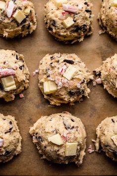 chocolate chip cookies with candy canes and butter on a baking sheet, ready to go into the oven