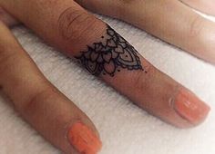 a person's foot with a tattoo on it and an orange nail polish vare