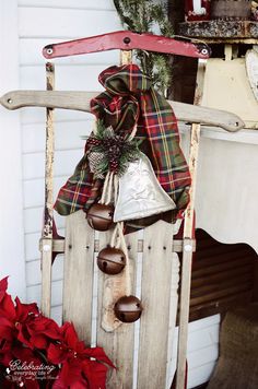 a wooden sled with bells and christmas decorations