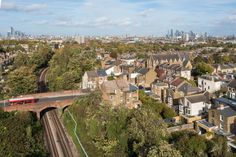 an aerial view of a city with houses and train tracks