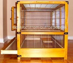 a wooden bird cage sitting on top of a hard wood floor