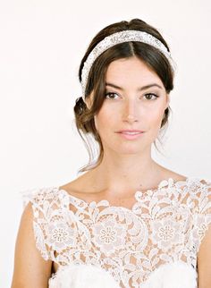 a woman wearing a white dress and a headband