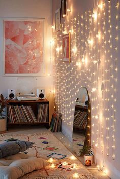 black and white photo of bedroom with lights on the wall, bedding and rug