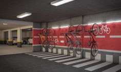 there are many bikes hanging on the wall in this gym area with red and white striped walls